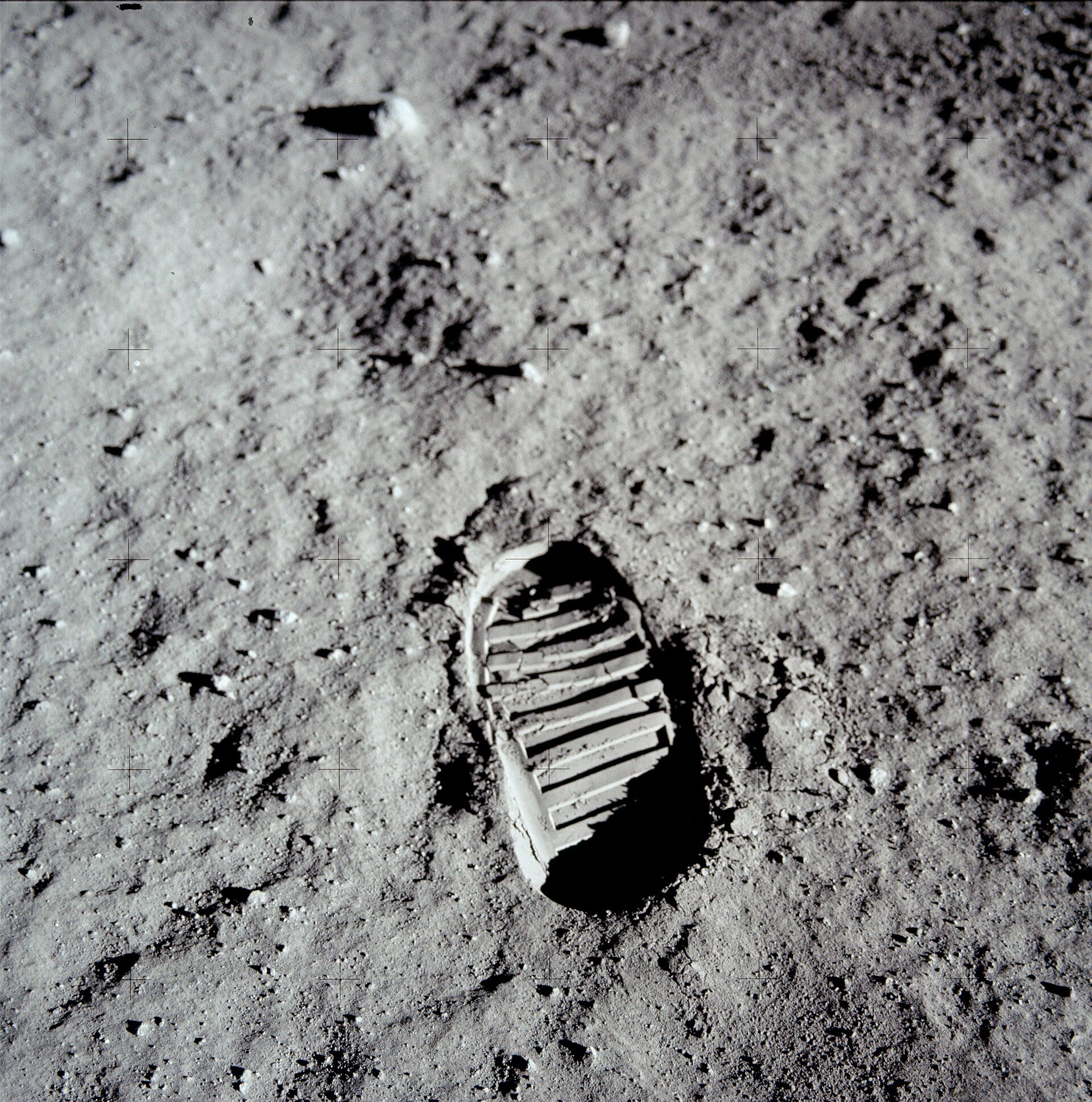 A close-up of Buzz Aldrin's bootprint pressed into the fine grey lunar soil