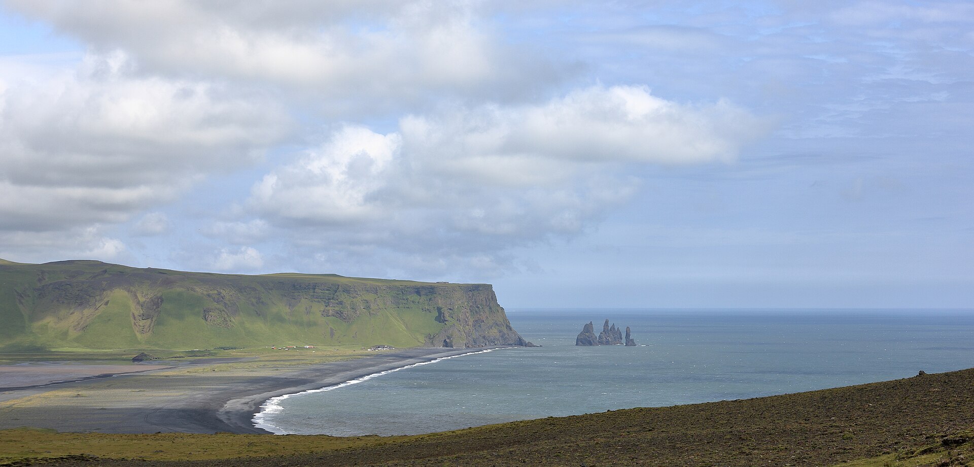 Aerial view of Reynisfjara black-sand beach and the Reynisdrangar sea stacks on Iceland's south coast