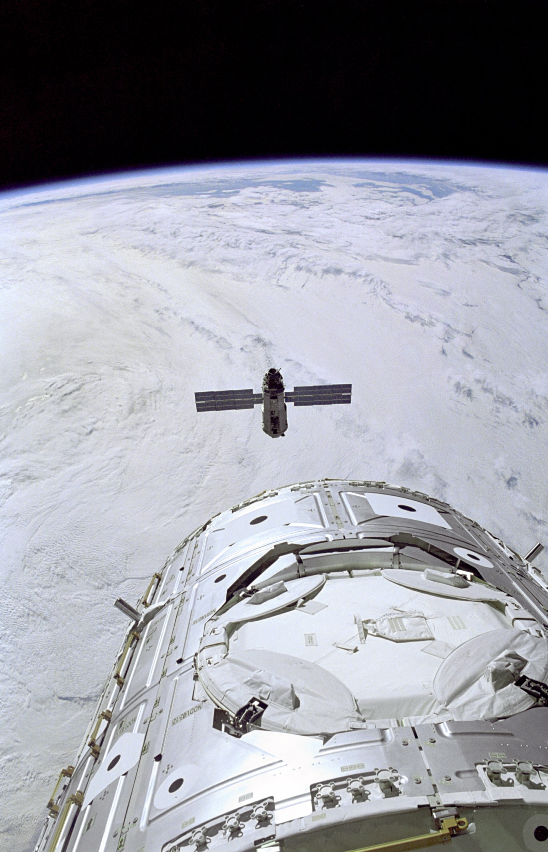 The Russian-built Zarya module approaching Space Shuttle Endeavour and the U.S.-built Unity node before capture in December 1998