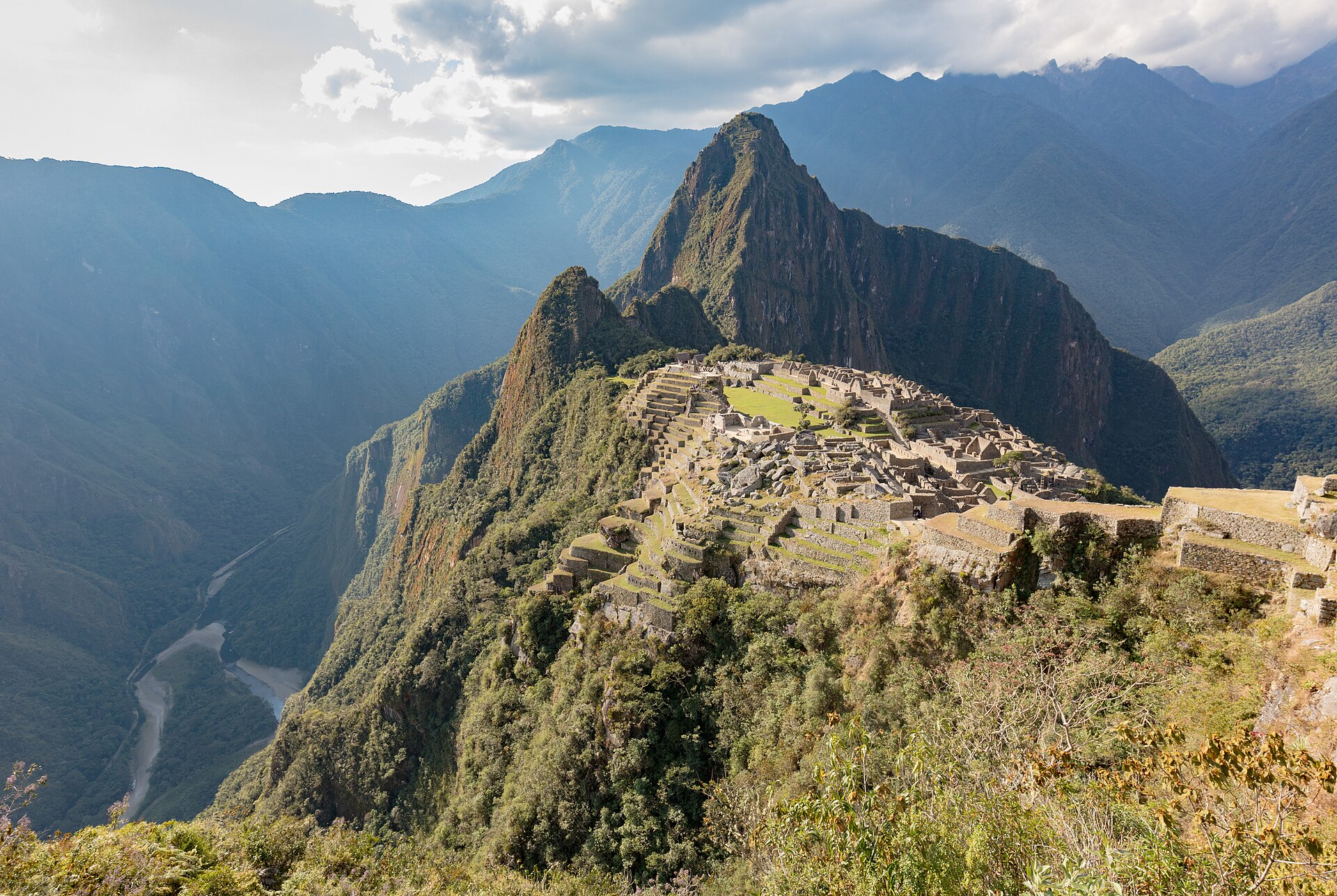 The Inka citadel of Machu Picchu on its granite ridge, with the peak of Huayna Picchu rising behind and the Urubamba gorge falling away at the left