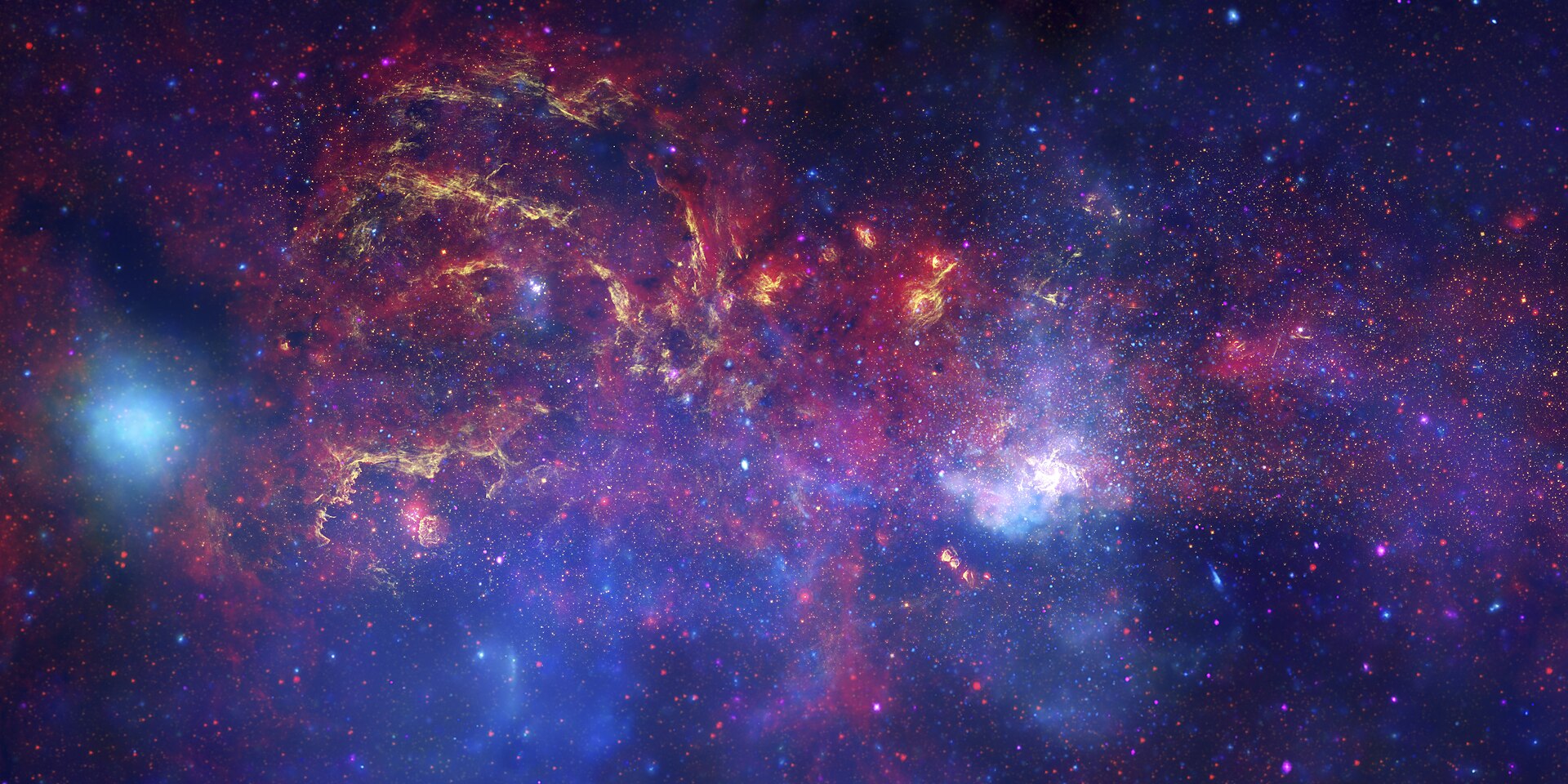 Wide composite image of the galactic centre combining X-ray, infrared and visible-light data, showing glowing clouds, dense star fields and the region of Sagittarius A*