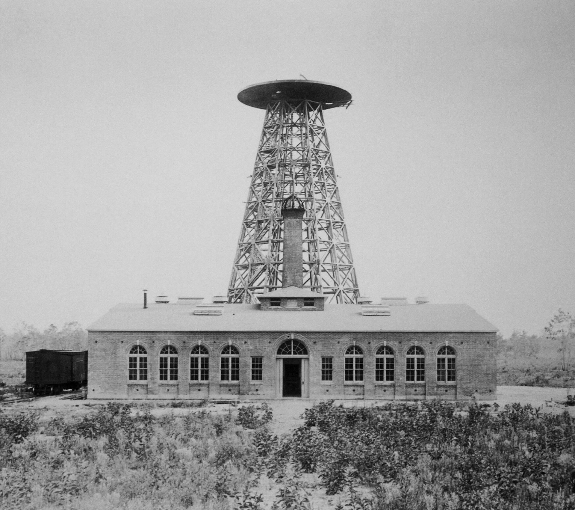 Wardenclyffe Tower, Tesla's 187-foot wireless transmission tower, with its brick laboratory building, Shoreham, Long Island, c. 1904