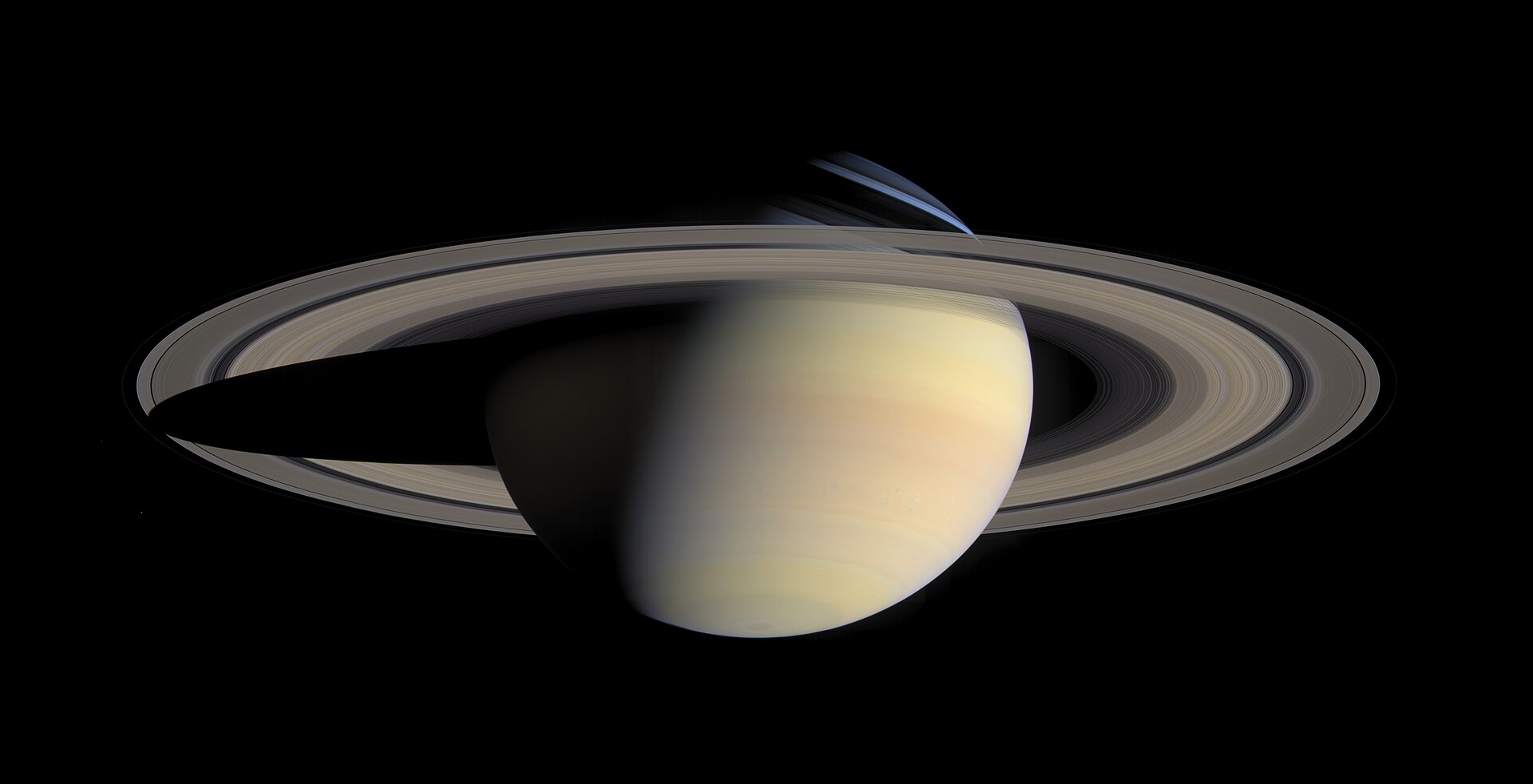 Saturn and its rings in natural color, a mosaic of 126 Cassini images taken on 6 October 2004, with the planet's shadow falling across the rings at left