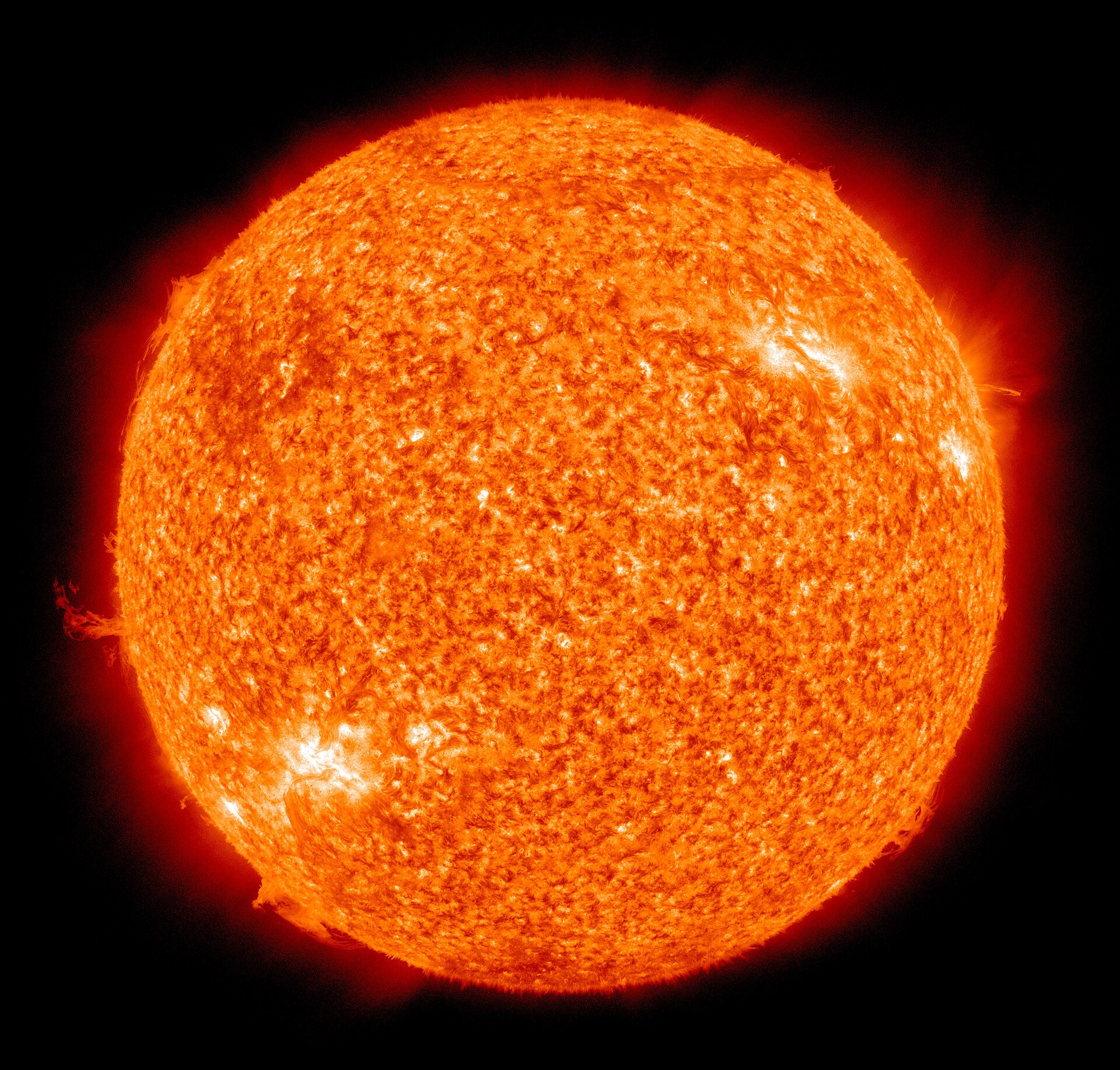 Full-disk image of the Sun in extreme ultraviolet light, showing glowing plasma and bright active regions across the solar surface